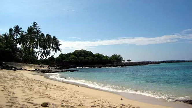 Empty white sand and clear shallows at Makalawena Beach on the Kona coast.