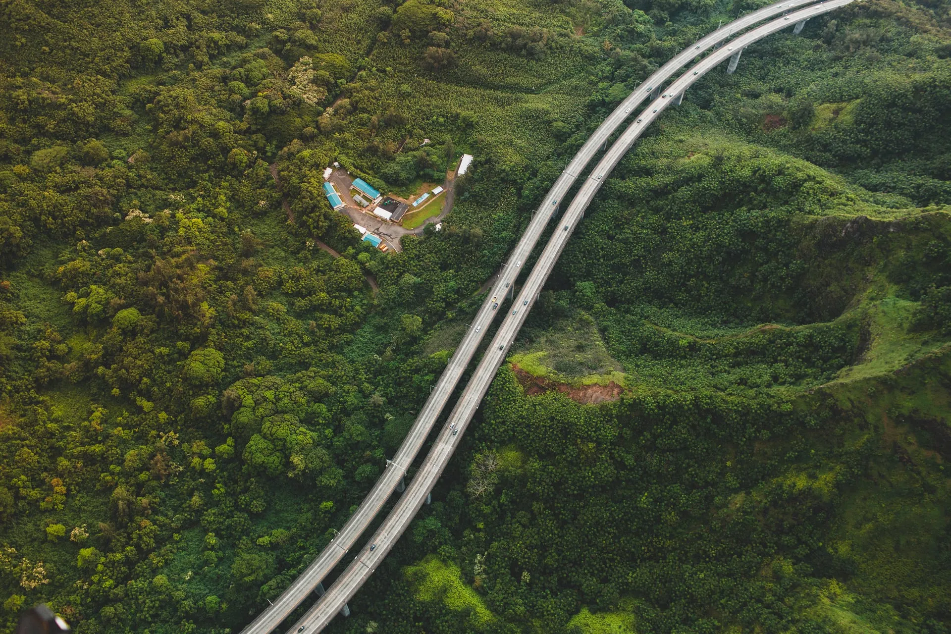 The H-3 freeway viaduct curving through the green Koolau mountains of Oahu.