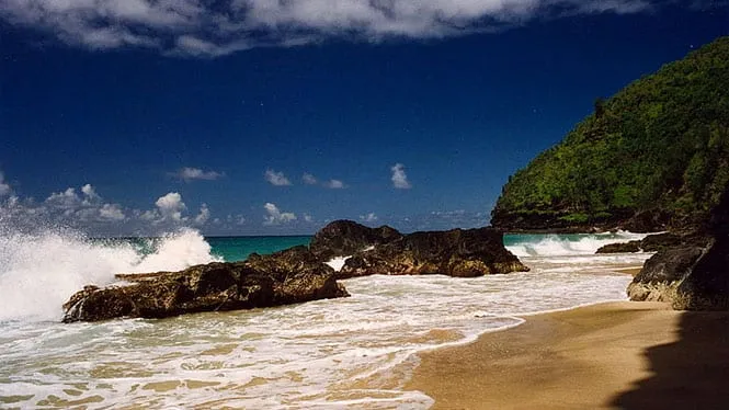 Surf crashing against the rocks at Hanakapiai Beach on the Kalalau Trail.