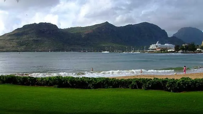 Kalapaki Beach fronting the resort lawn at Nawiliwili, with the Haupu ridge behind.