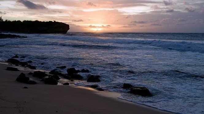 Sunrise over the Makawehi cliffs at Shipwreck (Keoneloa) Beach, Poipu.