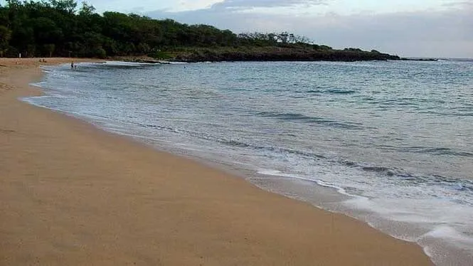 Calm water lapping the long sand at Manele Bay Beach, Lanai.