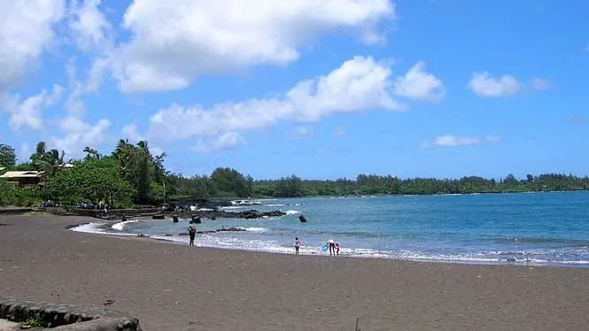 Hana Bay’s grey sand beach curving toward the pier, East Maui.