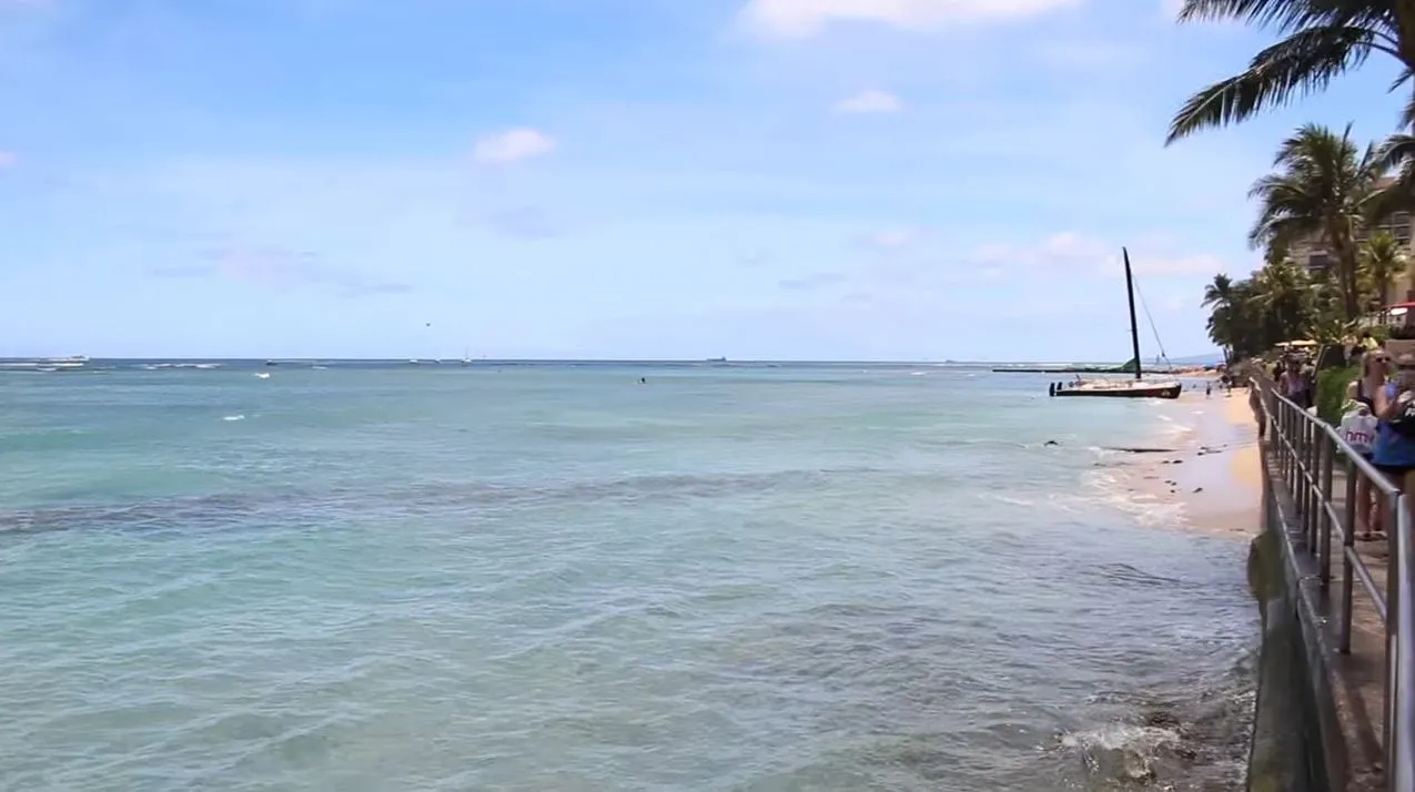 A catamaran pulled up at Gray’s Beach beside the Halekulani walkway, Waikiki.