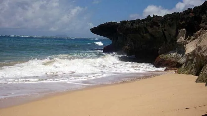 Surf washing into the small cove at Laniloa Beach below the sea cliffs at Laie.
