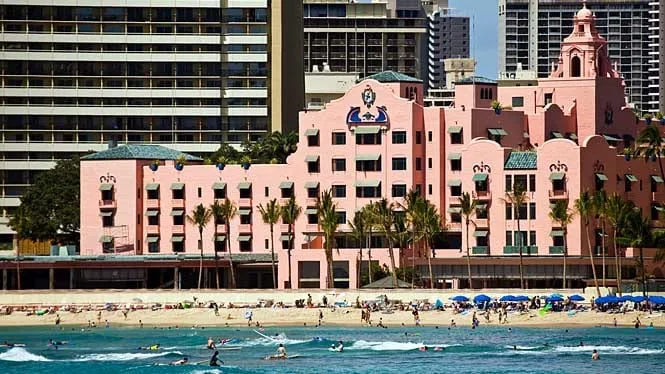 The pink Royal Hawaiian Hotel above the crowded sand of Royal Hawaiian Beach, Waikiki.