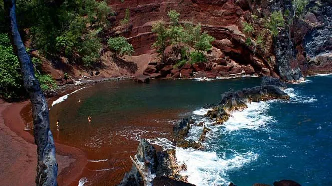 Red cinder sand and turquoise water inside the cove at Kaihalulu, Hana.