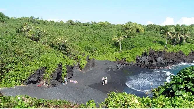 The black sand cove at Waianapanapa State Park ringed by green cliffs near Hana.